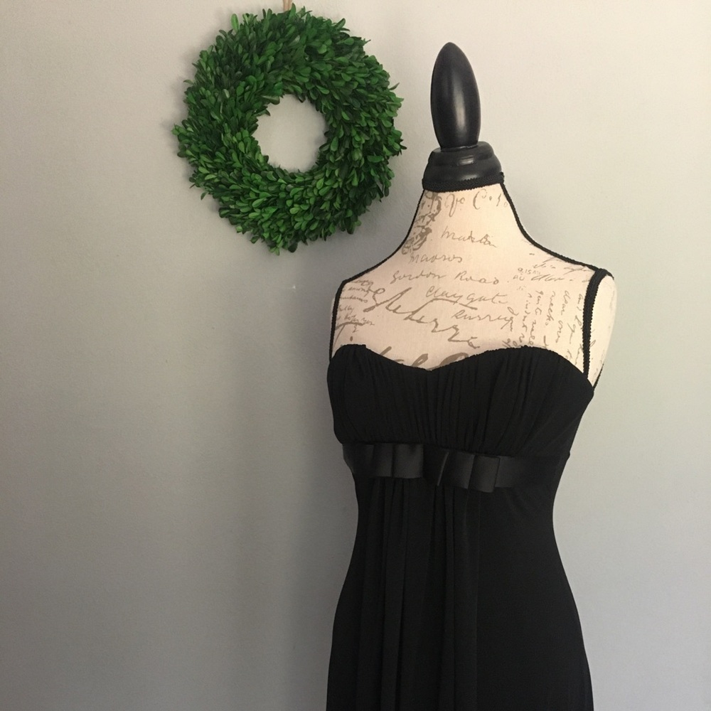Black cocktail dress. Strapless with empire waist bow detail.
